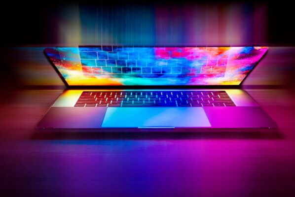 A laptop partly open with colours displayed on screen representing AI rather than a person