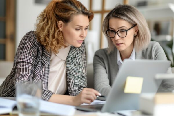 Two women looking at cashflow and investment plans on a laptop